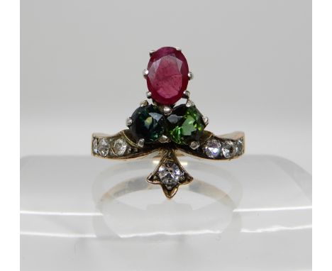 A 9ct gold ruby and sapphire ring further set with clear gems, size Q, weight 3.9gms Condition Report: Ruby quite included wi