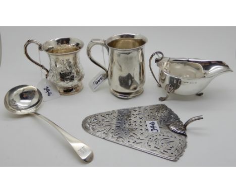 A lot comprising a silver tankard London 1929, a silver christening mug London 1848, a silver sauce ladle, a part silver cake