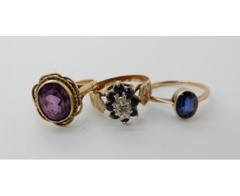 A 9ct sapphire and diamond accent ring, size S1/2, a 9ct blue gem set ring size Q1/2, and a yellow metal ring set with an ame