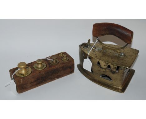 A vintage iron with hinged top and a set of graduated weights Condition Report: Available upon request