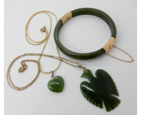 A yellow metal mounted green hardstone bangle together with two British Columbia jade items Condition Report: Available upon 