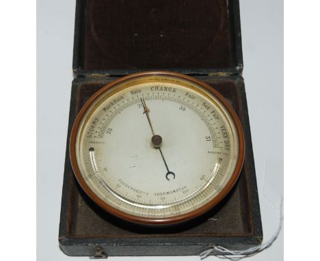 A vintage barometer in case, 13.5cm wide Condition Report: Available upon request