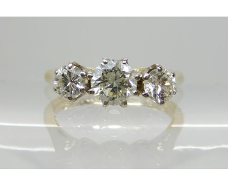 An 18ct gold three stone diamond ring, of estimated approx 0.75cts, finger size K, weight 3gms Condition Report: Inner shank 