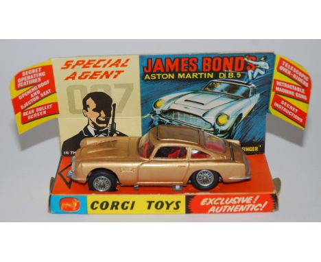 A Corgi 261 James Bond Aston Martin D.B.5 with associated contents and badge, lacking a figure, a Corgi 267 Rocket Firing Bat