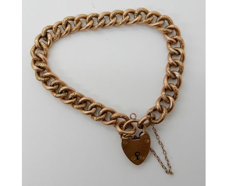 A 9ct gold curb link bracelet with heart shaped clasp, length 18.5cm, weight 12.4gms Condition Report: Hollow construction, n