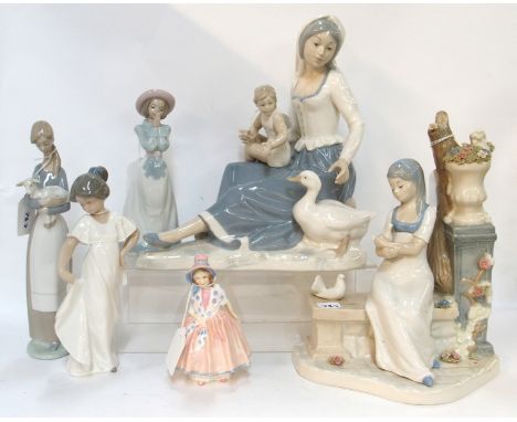 A Royal Doulton figure Lily together with a Lladro figure of a girl and lamb, two Nao figures and two other figures Condition