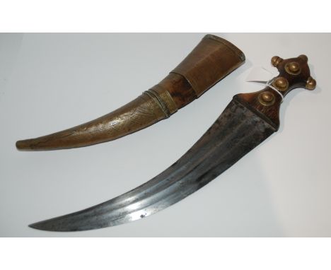 A middle eastern dagger with decorative metal scabbard, hilt and blade, 42cm Condition Report: Available upon request