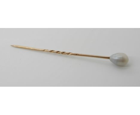 A yellow metal pearl topped pin, the pearl with subtle lustre is drop shaped approx 10mm x 7.5mm. Length of pin including pea