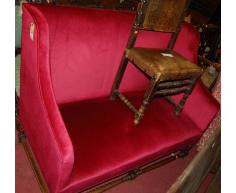 A circa 1900 walnut framed and upholstered two-seater wingback sofa, raised on turned supports united by low stretchers, w.13