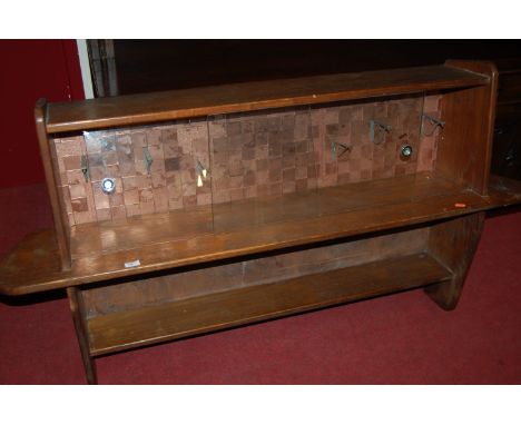 A 1960s elm hanging display cabinet, having twin glazed sliding doors with interior hooks and integral lower shelf, w.135cm