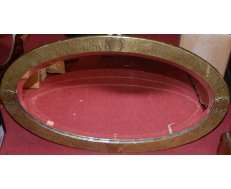 A bevelled and shaped oval wall mirror; a brass framed and bevelled oval wall mirror; and a Ray Goldsborough - Imola '94, lim