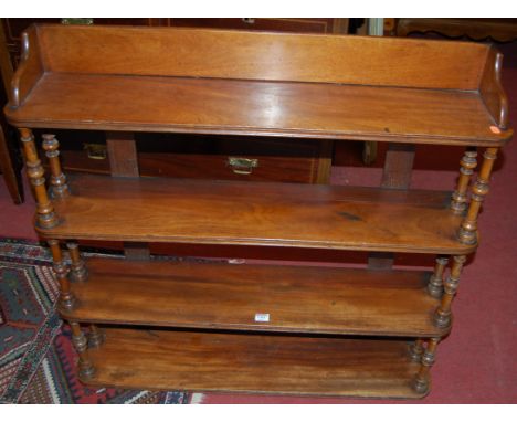 A Victorian mahogany round cornered four tier hanging wall shelf raised on double end turned supports, width 93cm