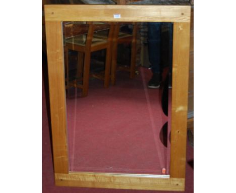 A light oak rectangular framed bevelled wall mirror, 100 x 70cm 