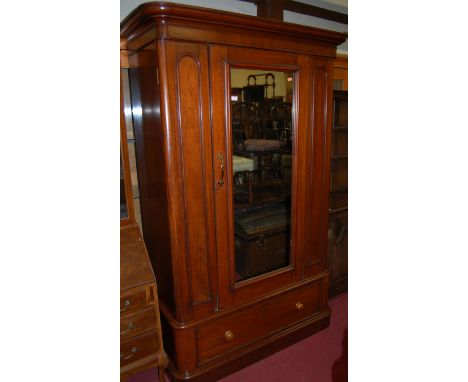 A mid-Victorian mahogany round cornered single mirror door wardrobe, having a single long lower drawer, w.130cm