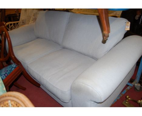 A modern sky blue upholstered three-seater sofa