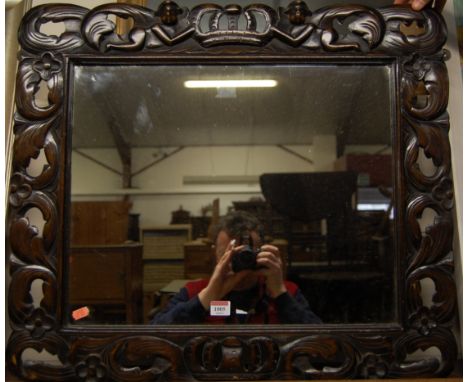 A carved and stained beechwood framed rectangular wall mirror, 64 x 72cm