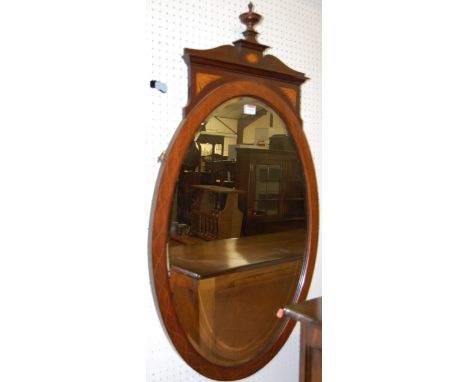 An Edwardian mahogany, satinwood inlaid, and further strung oval wall mirror (formally a dressing table mirror), 103 x 57cm