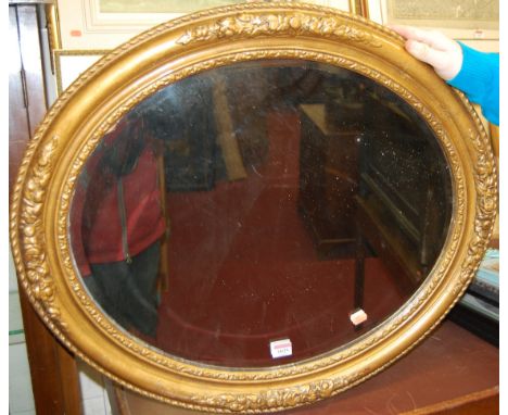A gilt framed and bevelled oval wall mirror, w.73cm