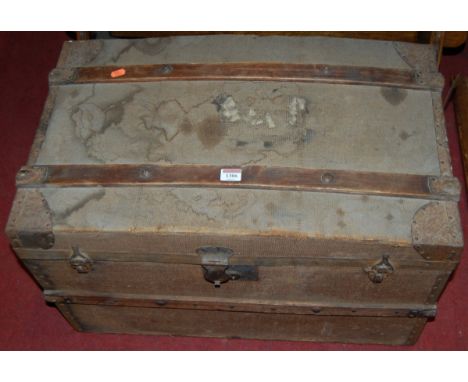 A circa 1900 canvas clad, wooden and metal bound hinge top travelling trunk having iron end carry handles, width 69cm