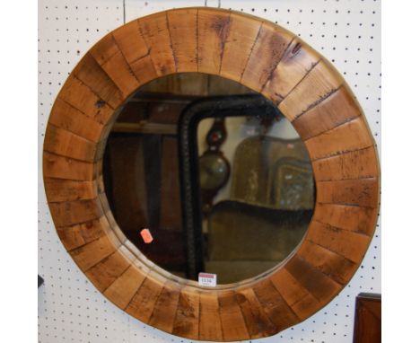 A contemporary stained pine circular wall mirror, dia. 58cm 