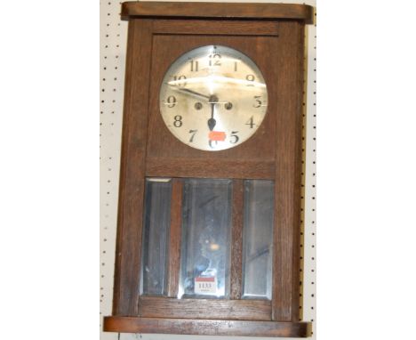 A 1930s oak droptrunk wall clock