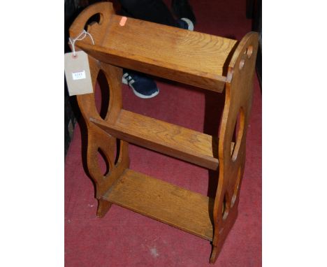 An Arts & Crafts two-tier book trough with lower platform and pierced cut out sides, together with a 19th century mahogany ov