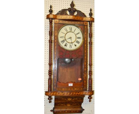 An early 20th century walnut and inlaid droptrunk wall clock, having a white enamel dial with twin winding holes 