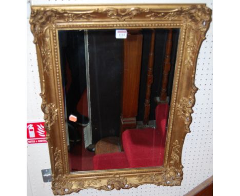 A giltwood floral decorated rectangular wall mirror, 70 x 51cm