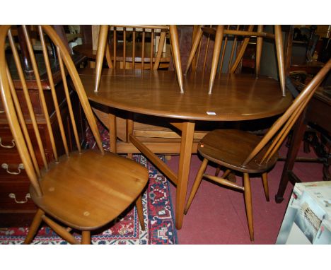 An Ercol mid elm dining suite comprising; drop leaf table with gateleg action and a set of six stickback chairs (7)