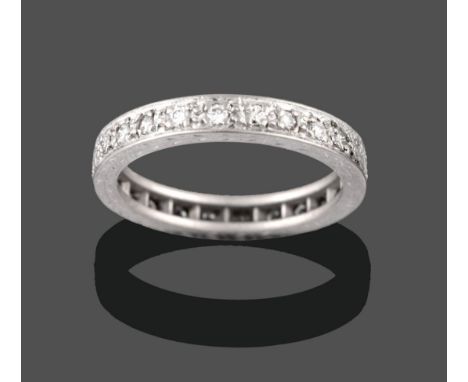 An 18 Carat White Gold Diamond Eternity Ring, the round brilliant cut diamonds in claw settings, with engraved sides, total e