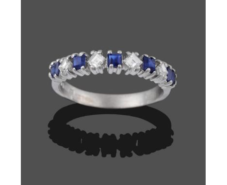 An 18 Carat White Gold Sapphire and Diamond Half Hoop Ring, square step cut sapphires alternate with diagonally placed square