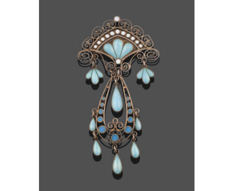 An Arts &amp; Crafts Style Enamel Brooch, the white shield motif with scroll work surround to a central pear shaped drop, wit