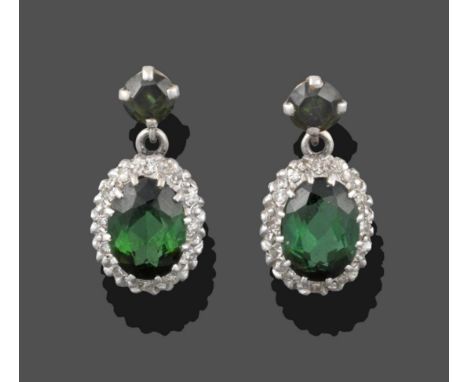 A Pair of Green Tourmaline and Diamond Cluster Drop Earrings, a round cut green tourmaline in a white claw setting suspends a