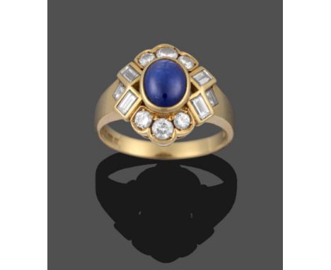 An 18 Carat Gold Sapphire and Diamond Ring, the oval cabochon sapphire in a yellow rubbed over setting, within a border of ro