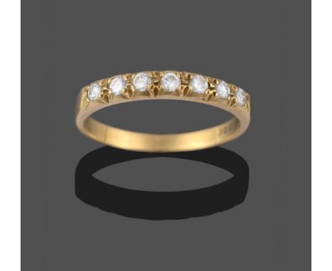 A Diamond Half Hoop Ring, seven round brilliant cut diamonds in yellow claw settings, to a plain polished shank, total estima