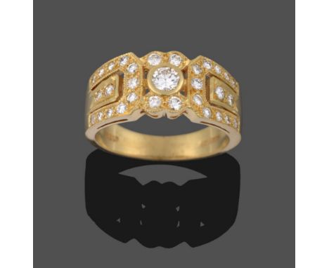 An 18 Carat Gold Diamond Ring, a central cluster of round brilliant cut diamonds within geometric shoulders inset with furthe