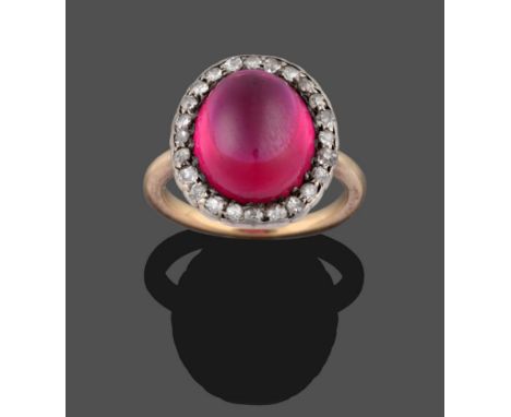 A Synthetic Ruby and Diamond Cluster Ring, the oval cabochon synthetic ruby within a border of old cut diamonds in white claw