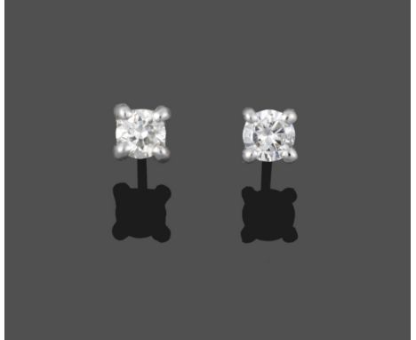 A Pair of 18 Carat White Gold Diamond Solitaire Earrings, the round brilliant cut diamonds in four claw settings, total estim