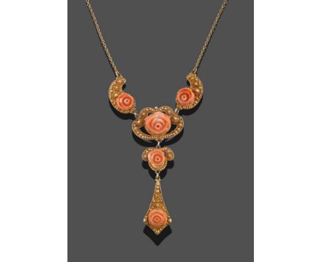 A Coral Necklace, three graduated carved coral roses to a central drop of two carved coral roses, on vari-shaped yellow panel