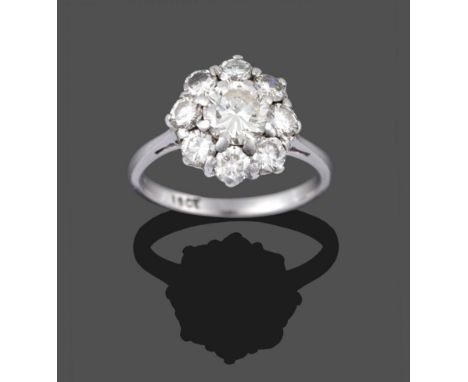 A Diamond Cluster Ring, a round brilliant cut diamond within a border of eight smaller round brilliant cut diamonds, in white