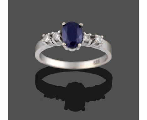 A Sapphire and Diamond Five Stone Ring, the central oval cut sapphire flanked by two round brilliant cut diamonds each side i