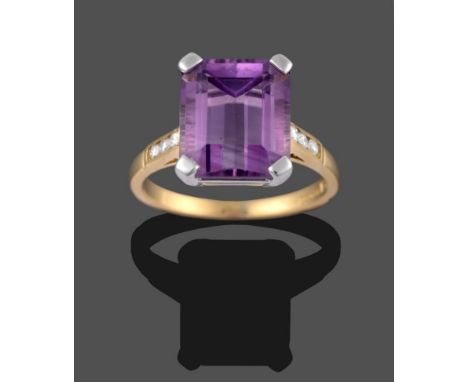 An 18 Carat Gold Amethyst and Diamond Ring, the emerald-cut amethyst in a white corner claw setting, to shoulders channel set