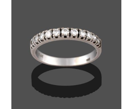 A Diamond Half Hoop Ring, eleven round brilliant cut diamonds in white claw settings to a plain polished shank, total estimat