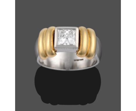 A Contemporary Platinum Diamond Solitaire Ring, the princess cut diamond in a rubbed over setting, flanked by yellow double b