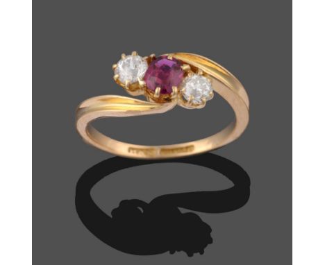 A Victorian 18 Carat Gold Ruby and Diamond Three Stone Ring, the cushion cut ruby between two old brilliant cut diamonds, in 