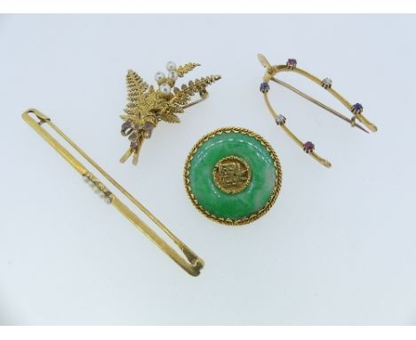 A collection of four gold mounted Brooches, including a Chinese circular jade disc, with gold centre and ropework border, the