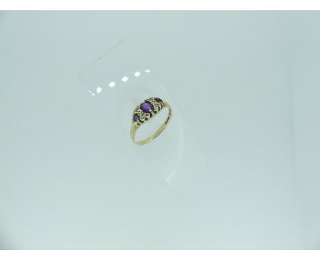 A small amethyst and diamond Ring, the three graduated amethysts with diamond points between, all mounted in 9ct yellow gold,