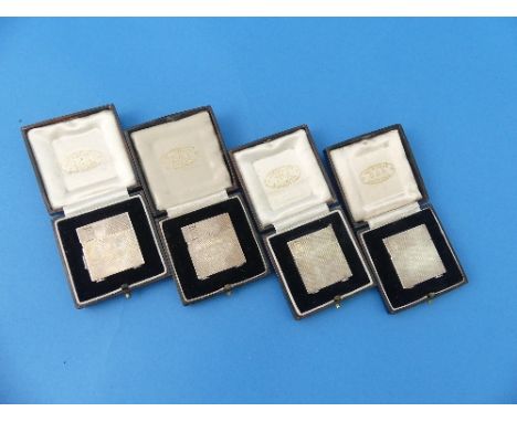 A set of four cased miniature Lighters, by S.P.Ora, hallmarked 1933 and 1938, each of hinged square form with engine turned d
