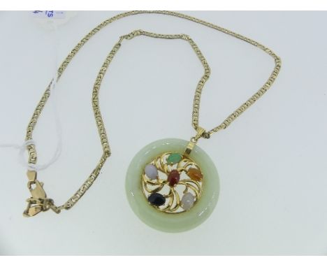 A Jade Pendant,  formed of and open circle, the centre with gold spokes set with various coloured stones, marked on the suspe
