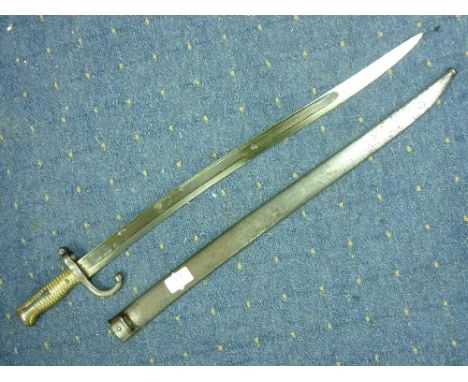 A French Franco-Prussian War period Bayonet and scabbard, circa 1870, the saber-style bayonet with 22½in (57cm) blade and bra